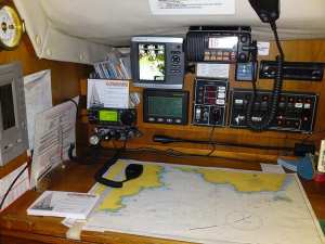 Christine Marie's navigation table.  IC706 Mk2G lower left, Marine VHF top.  GPS and Navtext left of VHF.